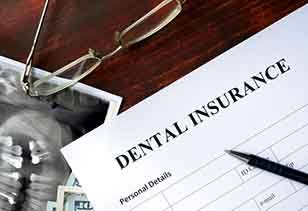 A dental insurance form on a wooden table